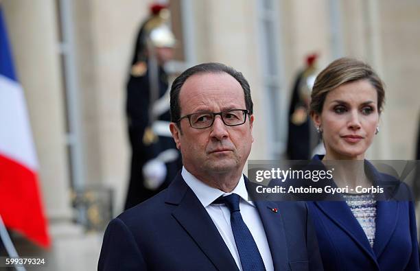 King Felipe of Spain, flanked by Queen Letizia, French President Francois Hollande are delivering a speech at the Elysée palace following the crash...