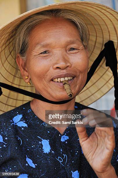 older senior woman smoking a cigar in nam dong, vietnam, southeast asia - beautiful women smoking cigars fotografías e imágenes de stock