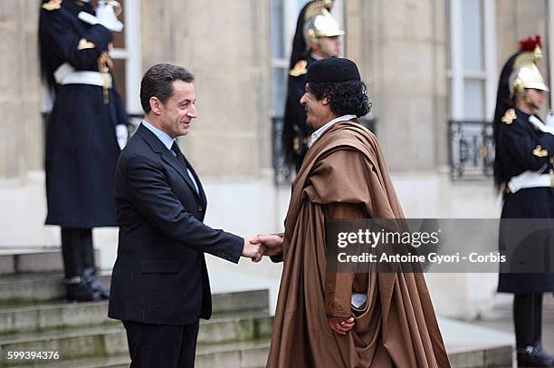 French President Nicolas Sarkozy greets Libyan leader Muammar Gaddafi at the Elysee Palace.