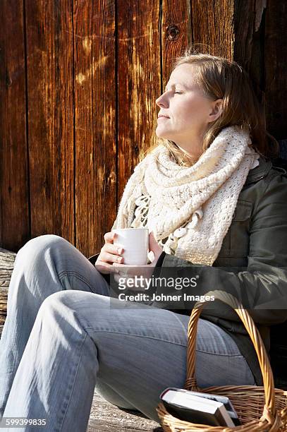 woman holding mug and relaxing - johner images bildbanksfoton och bilder