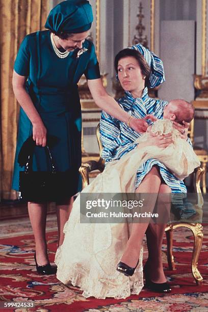 Queen Elizabeth II with her daughter, Princess Anne and grandson, Peter Phillips at the baby boy's christening, 12th December 1977.