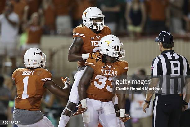 Onta Foreman of the Texas Longhorns celebrates with teammates after scoring a 19-yard rushing touchdown during the fourth quarter against the Notre...