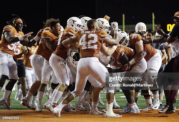 The Texas Longhorns celebrate defeating the Notre Dame Fighting Irish 50-47 in a second overtime at Darrell K. Royal-Texas Memorial Stadium on...