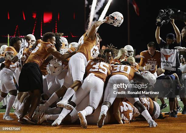 The Texas Longhorns celebrate defeating the Notre Dame Fighting Irish 50-47 in a second overtime at Darrell K. Royal-Texas Memorial Stadium on...