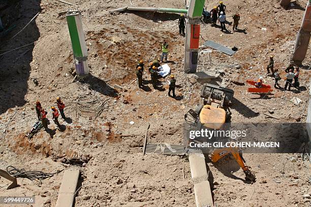 Israeli medics and emergency units work at a construction site where an underground car park collapsed on September 5, 2016 in the Ramat Hahayal...