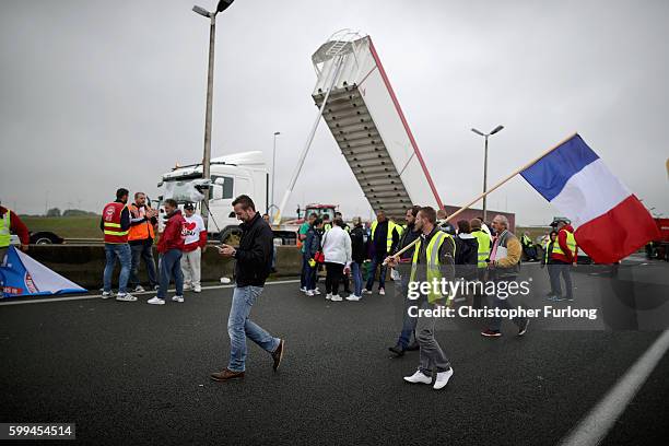 French farmers, truckers and local business owners blockade the main A16 motorway into the Channel Tunnel terminal protesting against the Jungle...