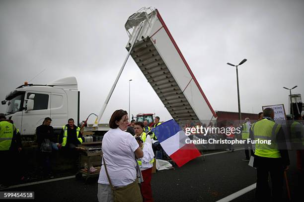 French farmers, truckers and local business owners blockade the main A16 motorway into the Channel Tunnel terminal protesting against the Jungle...