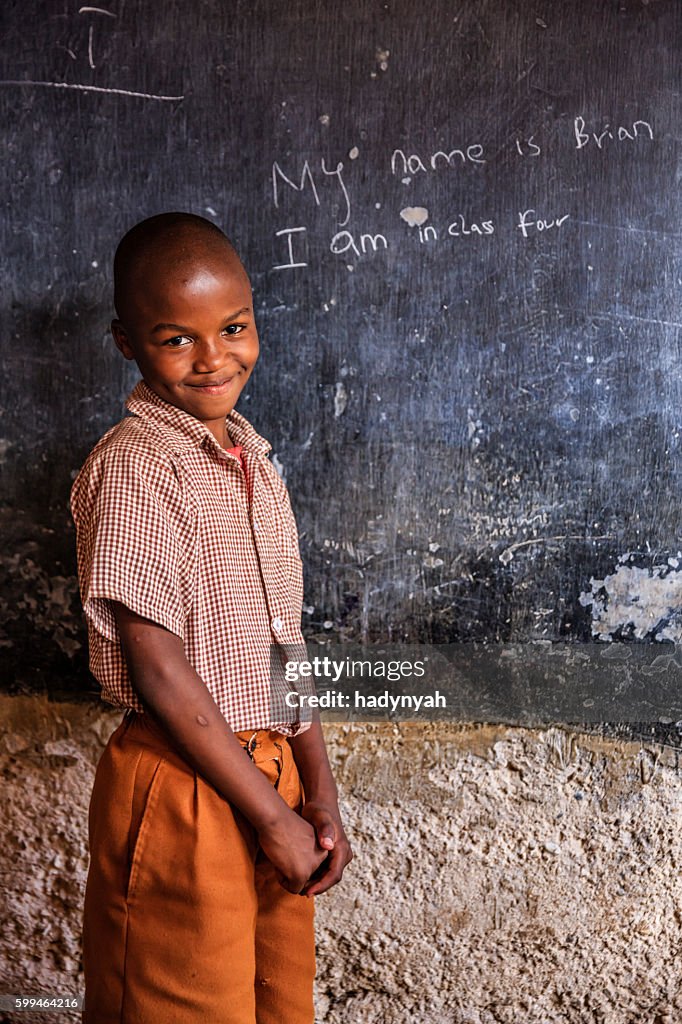 African young boy is learning English language, orphanage in Kenya