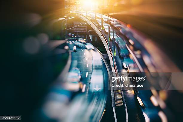 blurred traffic in central district - city streetlights stock pictures, royalty-free photos & images