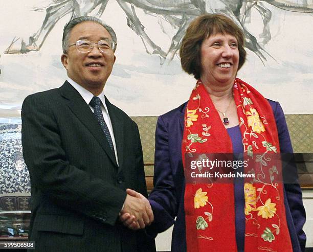 China - EU foreign policy chief Catherine Ashton shakes hands with Chinese State Councilor Dai Bingguo in Beijing on July 10, 2012.