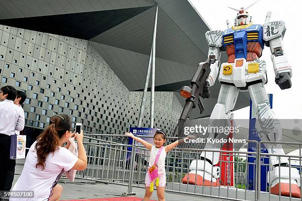 China - Japanese toy maker Bandai Co. Sets up a 6-meter-tall statue of Mobile Suit Gundam from a popular Japanese animation series at a comics and...