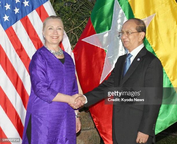 Cambodia - U.S. Secretary of State Hillary Clinton and Myanmar President Thein Sein shake hands before their meeting in Siem Reap, Cambodia, on July...