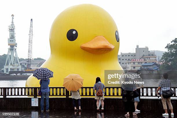 Onomichi, Japan - Rubber Duck, a 10-meter-tall rubber ducky created by Dutch artist Florentijn Hofman, is displayed on a river during a festival in...