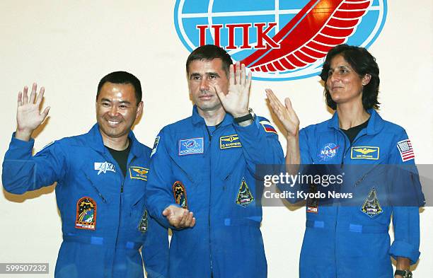 Kazakhstan - Japanese astronaut Akihiko Hoshide, Russian cosmonaut Yuri Malenchenko and NASA astronaut Sunita Williams wave after a press conference...