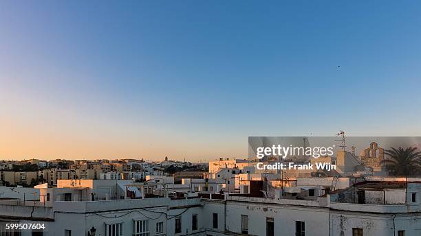 rooftops of tarifa at sunset - wijn stock pictures, royalty-free photos & images