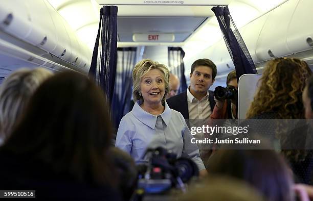 Democratic presidential nominee former Secretary of State Hillary Clinton chats with reporters aboard her new campaign plane at Westchester County...