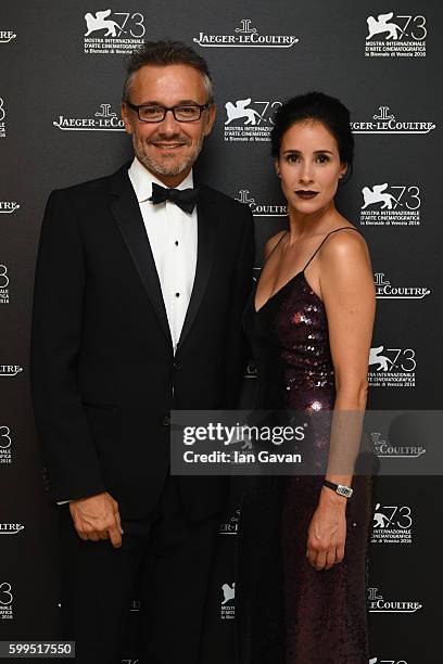 Olga Sutulova poses with Jaeger LeCoultre Communications Director Laurent Vinay in the Jaeger-LeCoultre lounge before attending the premiere of the...