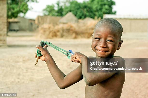 a boy with a slingshot - commerceandculturestock stock pictures, royalty-free photos & images