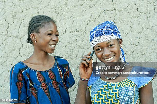 two happy girls with a mobile phone - commerceandculturestock stock pictures, royalty-free photos & images