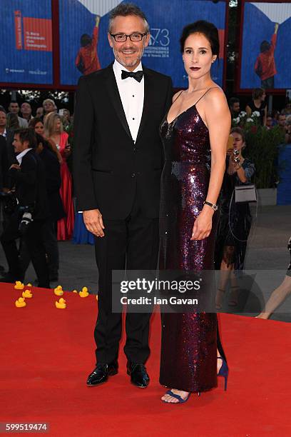 Olga Sutulova poses on the red carpet wearing a Jaeger-LeCoultre watch with Jaeger LeCoultre Communications Director Laurent Vinay during the...