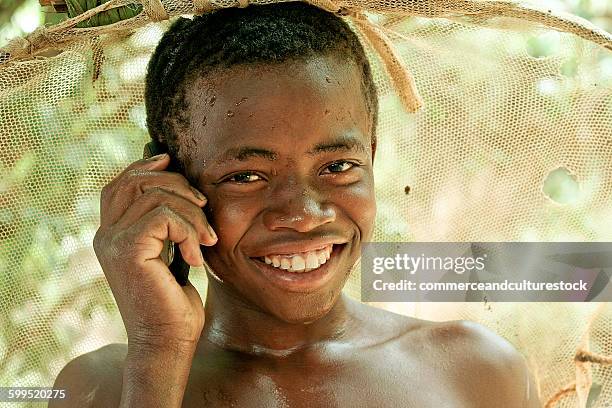 a smiling young farmer having a call - commerceandculturestock stock pictures, royalty-free photos & images