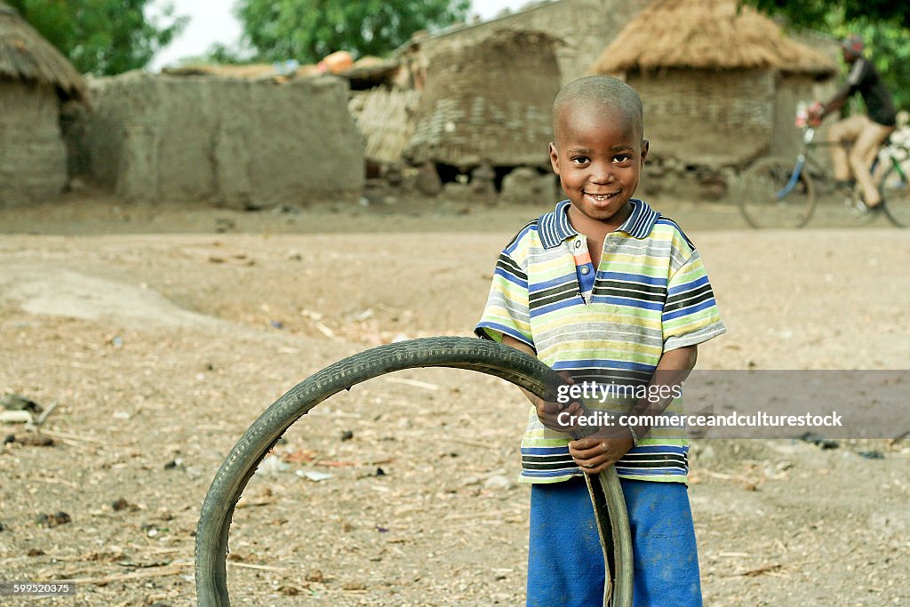 A small boy with a bicycle tire