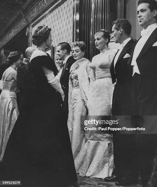 Queen Elizabeth II and Princess Margaret meets with film stars after the Royal Film performance of 'The Battle of the River Plate' John Gregson,...