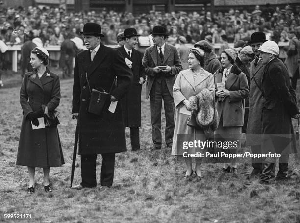 Queen Elizabeth II pictured left with Queen Elizabeth the Queen Mother and Princess Margaret along with the Royal jockey Dick Francis , in the...