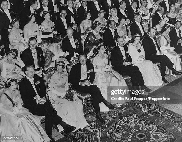 Royal figures of Europe sit together in the front row of the audience of a festival performance; Princess Margaret, Prince Philip, Duke of Edinburgh,...