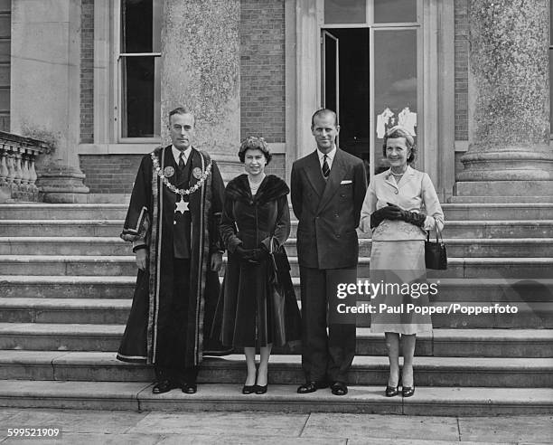 Queen Elizabeth II and Prince Philip, Duke of Edinburgh pictured together on the steps of Broadlands with Louis Mountbatten, 1st Earl Mountbatten of...