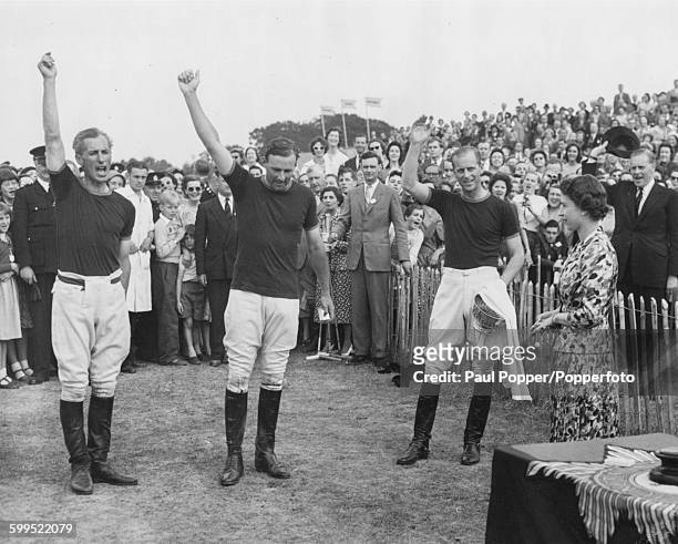 Prince Philip, Duke of Edinburgh calls for three cheers from the crowd for his polo team as they are presented with the Invitation Cup by his wife,...