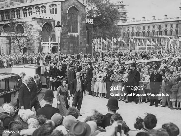Queen Elizabeth II is greeted by crowds of people as she arrives for the inauguration of the International Parliamentary Union Conference at...