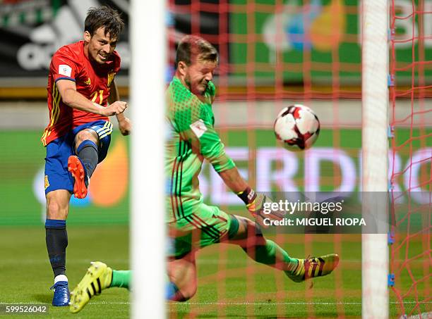 Spain's midfielder David Silva shoots against Liechtenstein's goalkeeper Peter Jehle during the WC 2018 football qualification match between Spain...