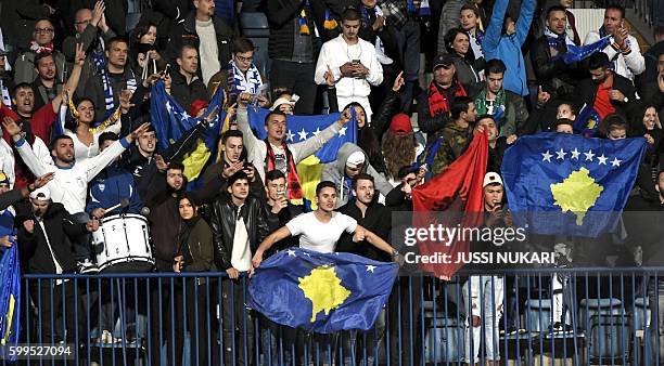 Kosovo's supporters celebrate at the end of the World Cup 2018 qualifying football match Finland vs Kosovo on September 5, 2016 in Turku. / AFP /...