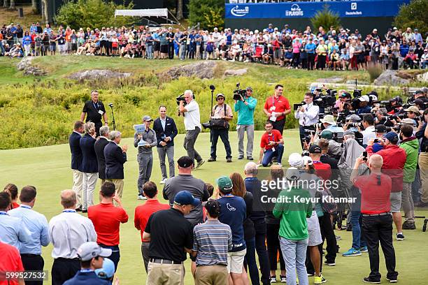 Rory McIlroy of Northern Ireland lifts the tournament trophy following his two stroke victory in the final round of the Deutsche Bank Championship at...
