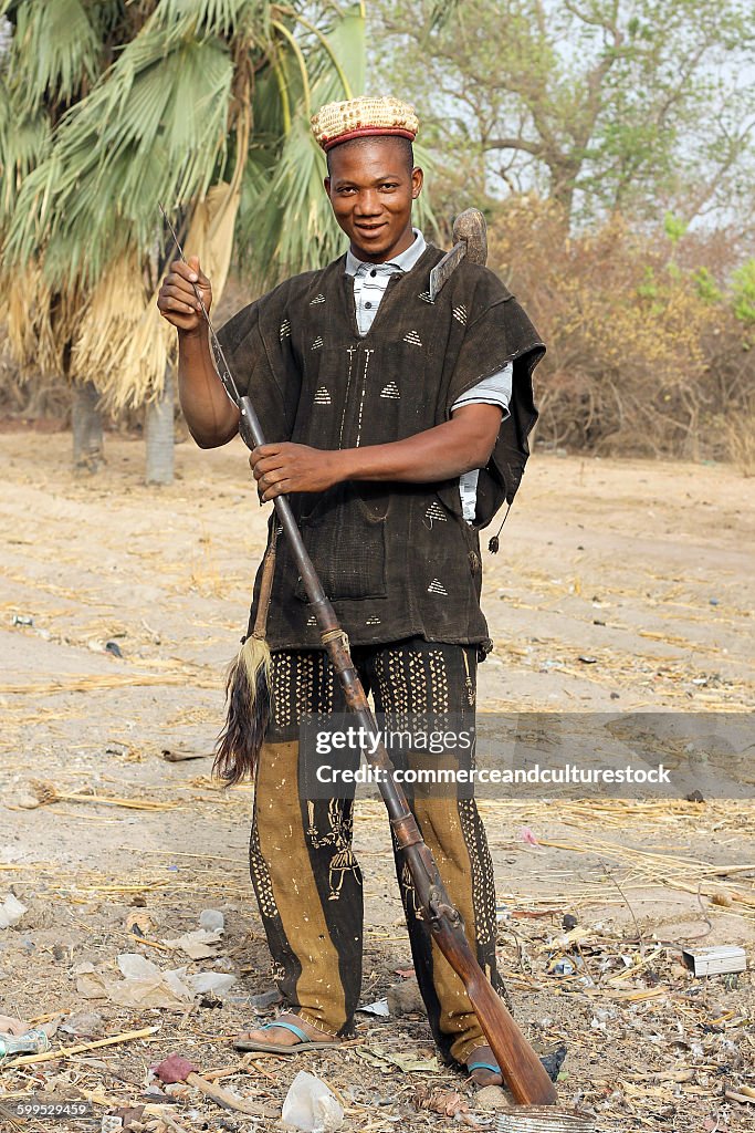 African hunter charging up his rifle