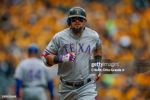 Rougned Odor of the Texas Rangers rounds the bases after hitting a solo home run against the Seattle Mariners in the sixth inning at Safeco Field on...