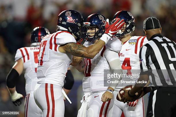 Evan Engram celebrates with Chad Kelly of the Mississippi Rebels after scoring a touchdown in the second quarter against the Florida State Seminoles...