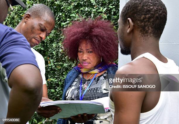 Ivorian actress, director and show creator Akissi Delta looks on at a film set during the shooting of the television series 'Ma Famille' in Abidjan...