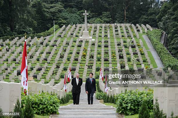 Canadian Prime Minister Justin Trudeau walks with British historian Tony Banham through the Sai Wan War Cemetery during his visit to Hong Kong on...