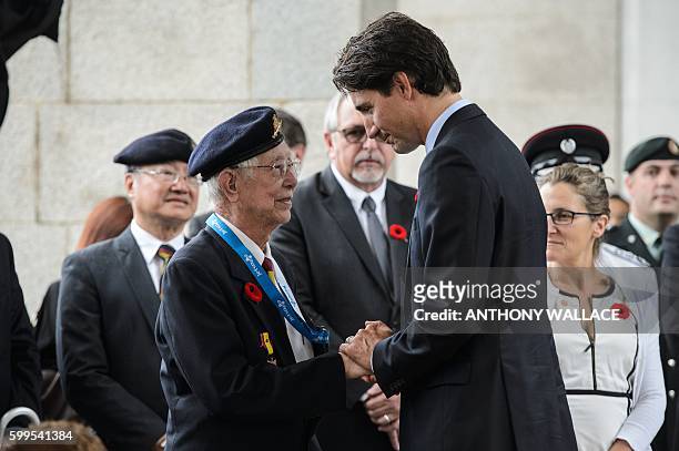 Veteran Peter Choi chairman of the WWII association of Hong Kong, shakes hands with Canadian Prime Minister Justin Trudeau at the Sai Wan War...