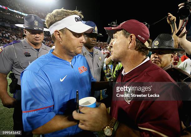 Head coach Hugh Freeze of the Mississippi Rebels and head coach Jimbo Fisher of the Florida State Seminoles talk after their game in the Camping...