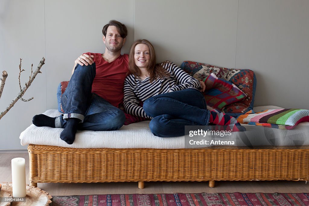 Couple lying on sofa, portrait