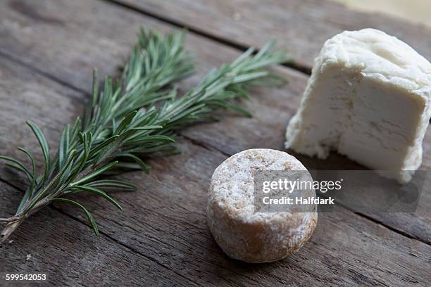 close-up of cheese and rosemary on table - queso de cabra fotografías e imágenes de stock