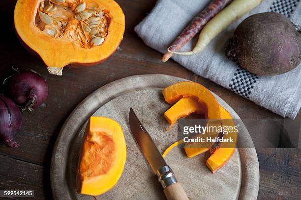 sliced squash on cutting board - hokaido pumpkin stock pictures, royalty-free photos & images