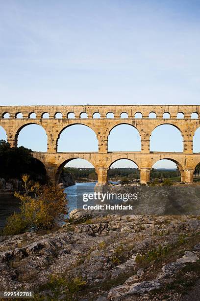 view of pont du gard over gardon river against sky - pont du gard aqueduct stock pictures, royalty-free photos & images