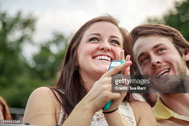 young man and sister clapping at graduation ceremony - sue clapper imagens e fotografias de stock