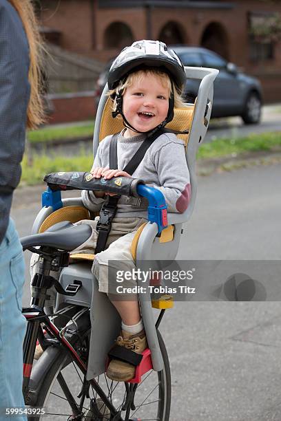 portrait of happy boy sitting on bicycle back seat - tobias materna imagens e fotografias de stock