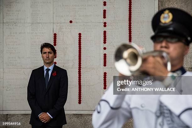 Canadian Prime Minister Justin Trudeau pauses before laying a wreath at the Sai Wan War Cemetery during his visit to Hong Kong on September 6, 2016....