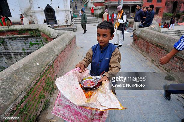 Young Priest holds Red Tika to stick on devotees at the Bank of Bagmati River of Pashupatinath Temple during Rishi Panchami Festival celebrations at...